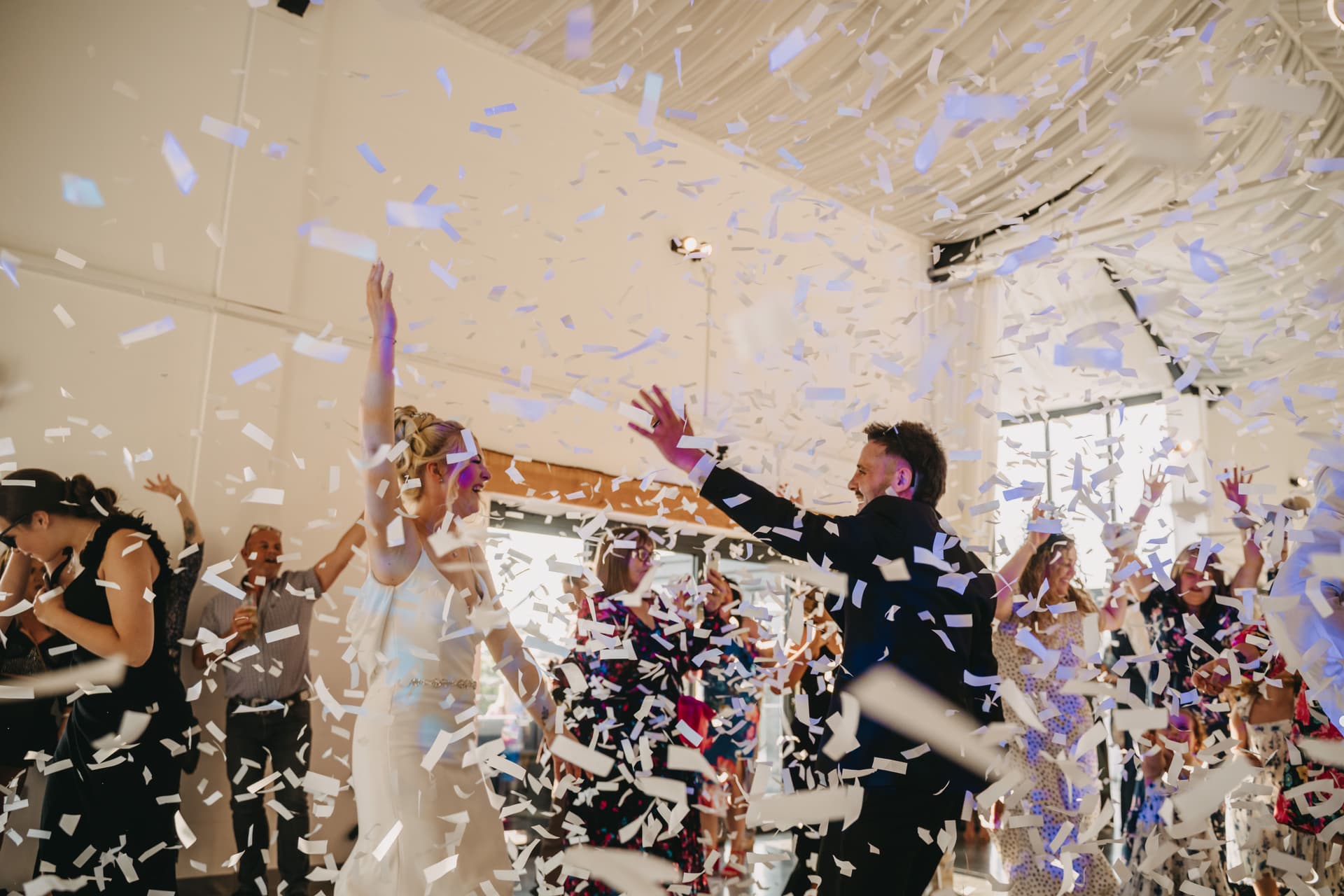 Couple dancing in raining confetti